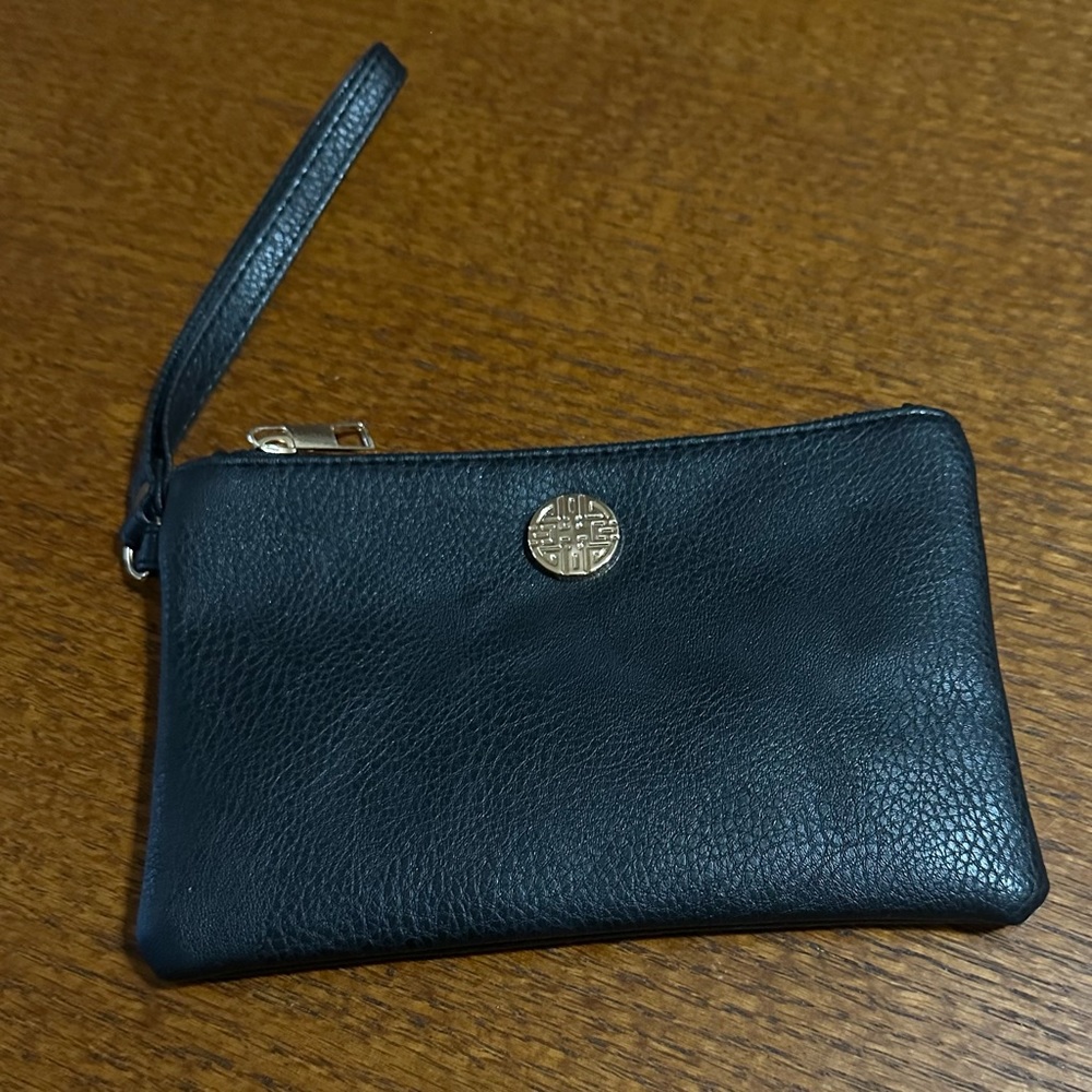 Small Black Wristlet with Gold Emblem.  Size is 7.5” Width x  5” Long.  NWOT!